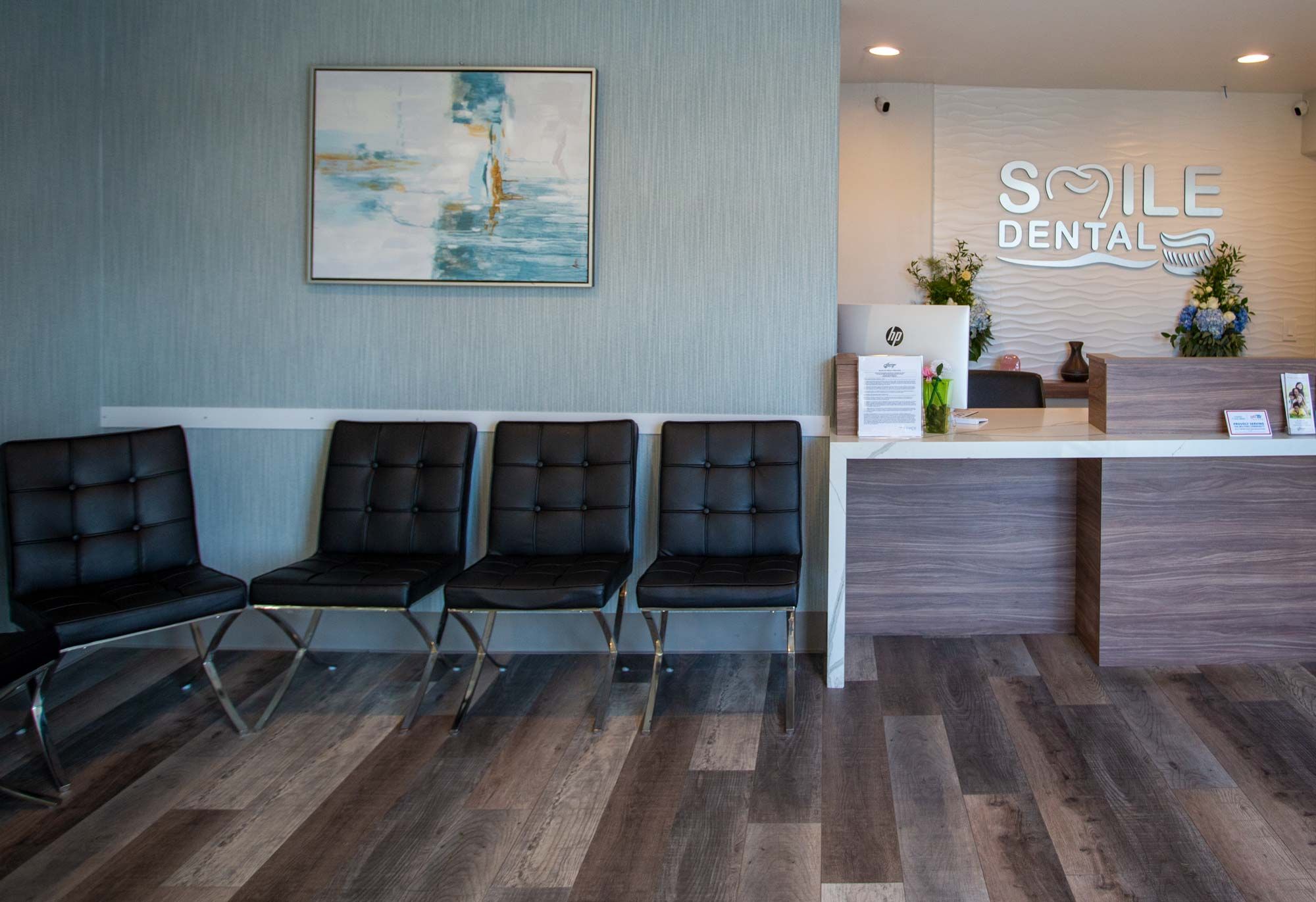 Smile Dental reception and waiting area with the logo wall