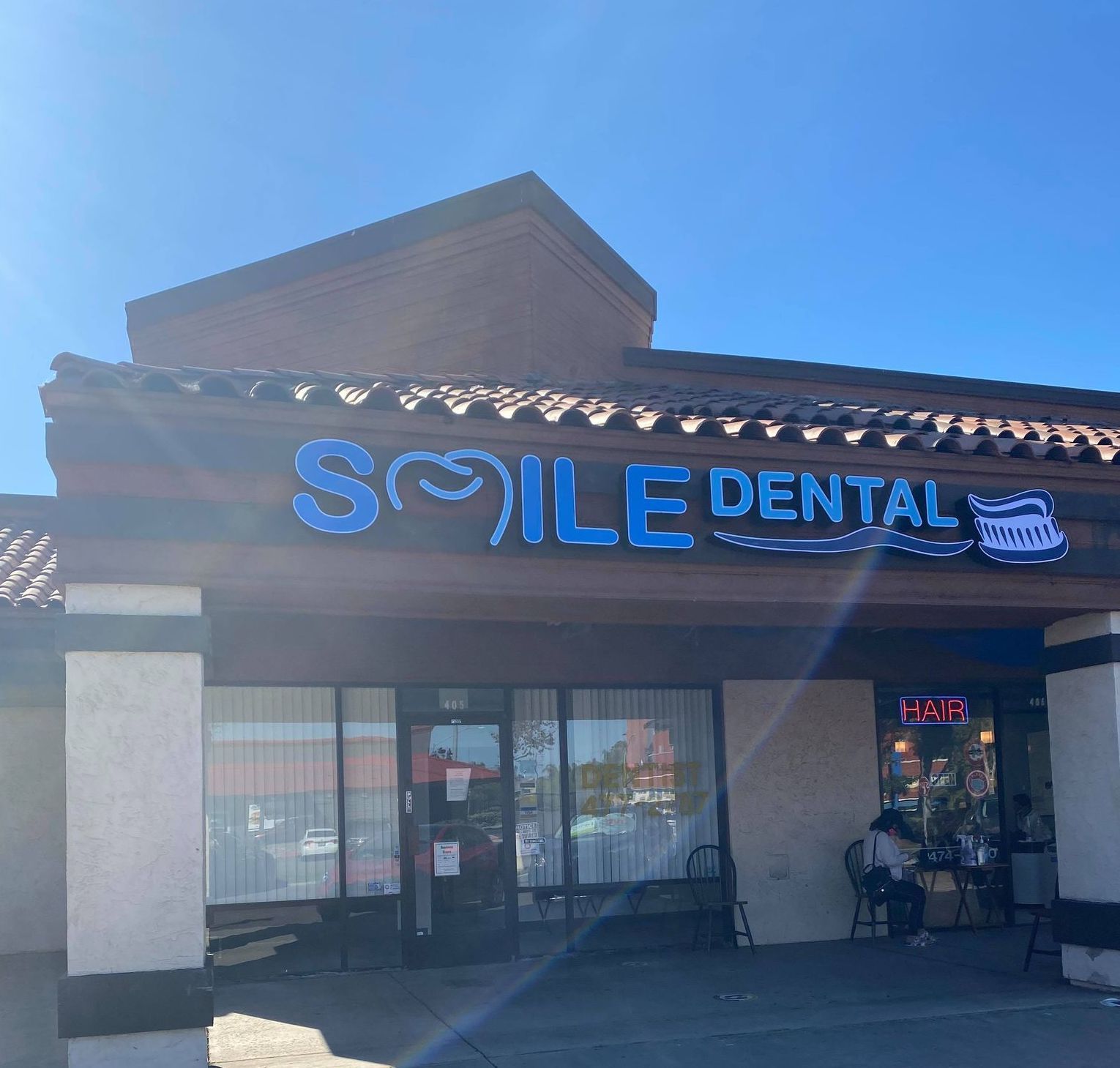 Smile Dental storefront with the illuminated sign, National City