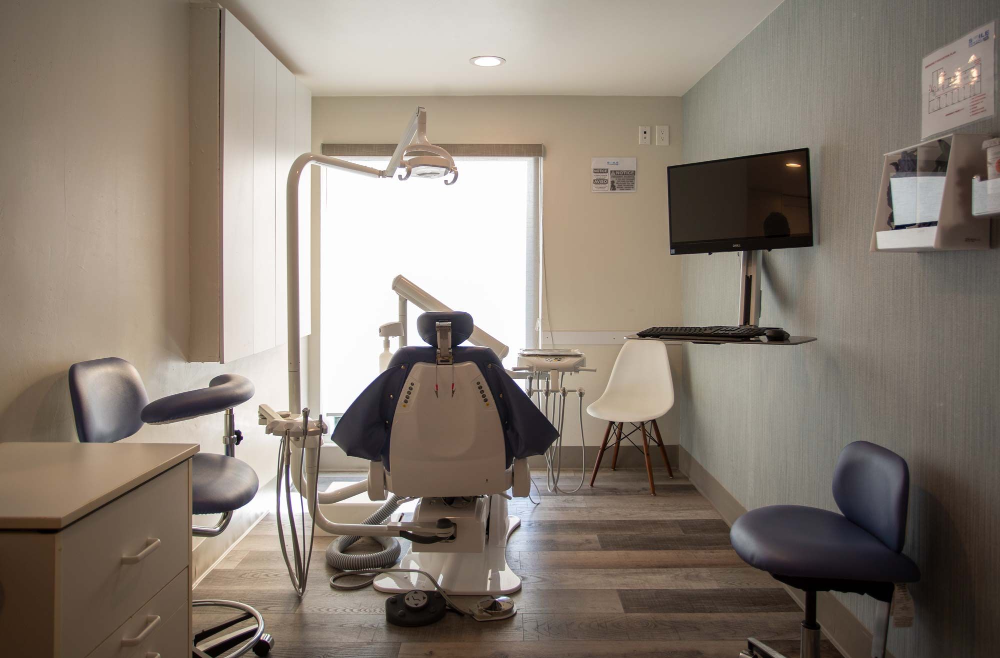 Smile Dental treatment room with dental chair and monitor